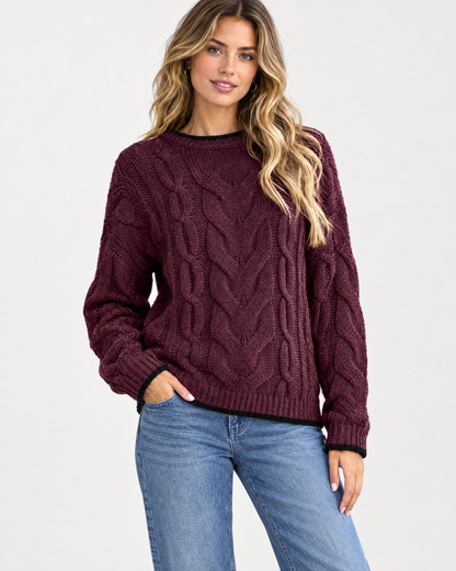 Woman wearing burgundy cable knit crewneck sweater with jeans